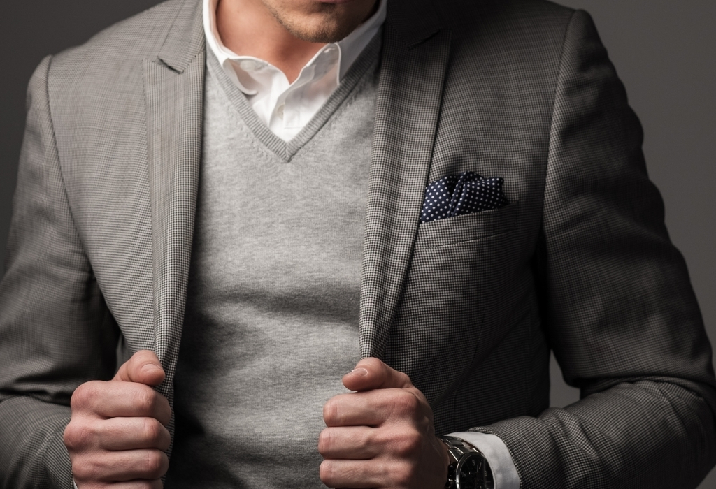 Man in grey sweater and suit jacket