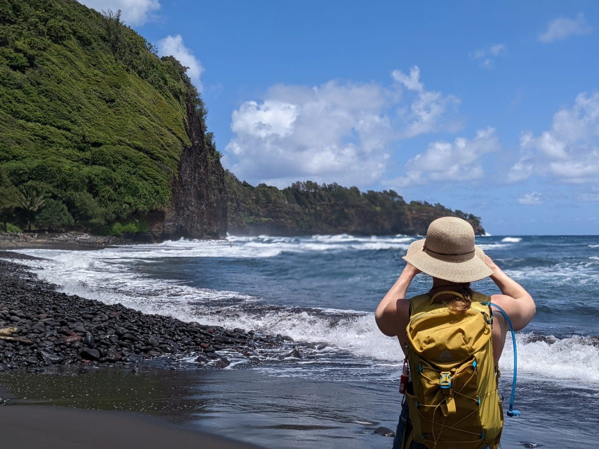 A tourist taking a picture of a beautiful beach view.