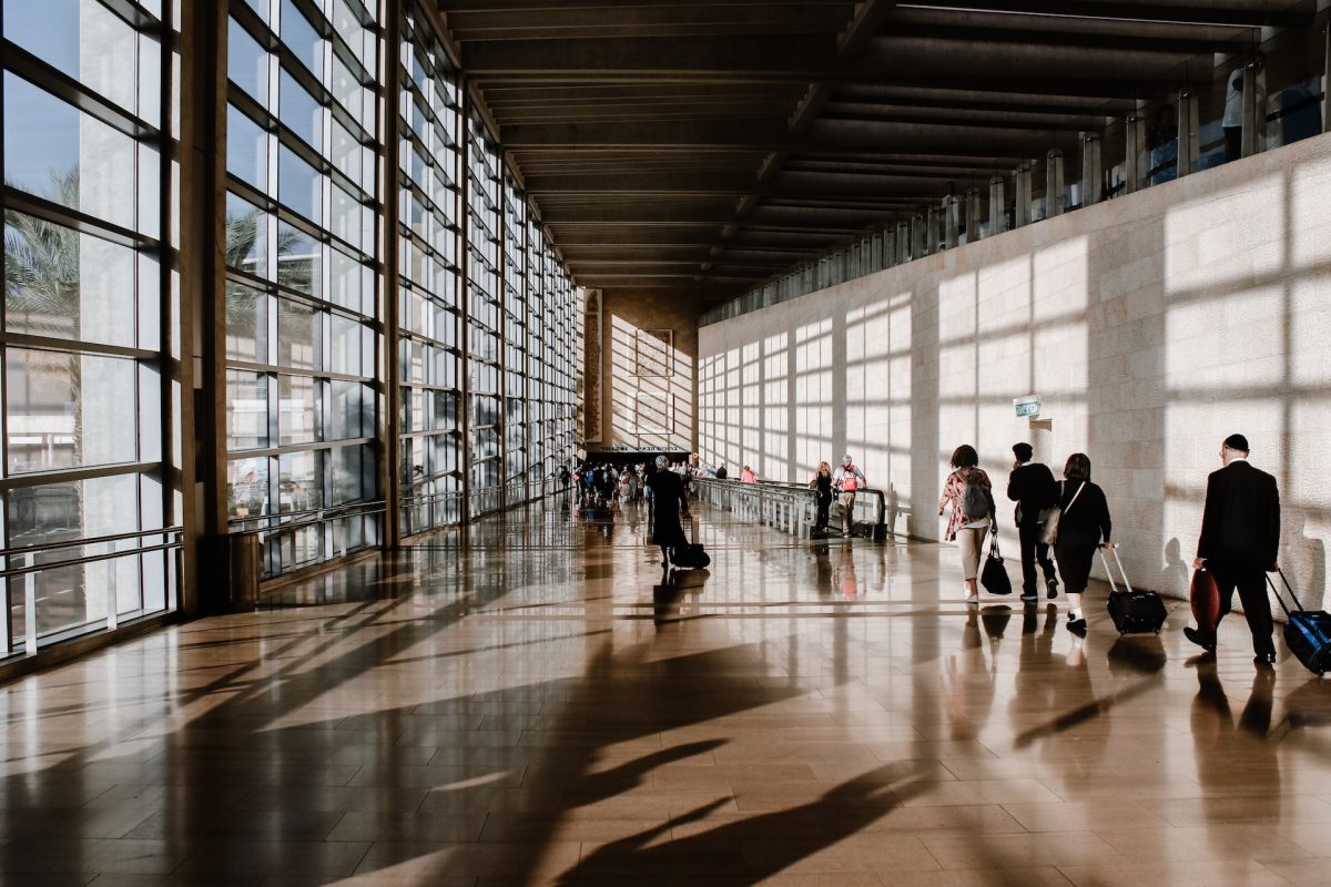 People walking to their destinations at the airport.