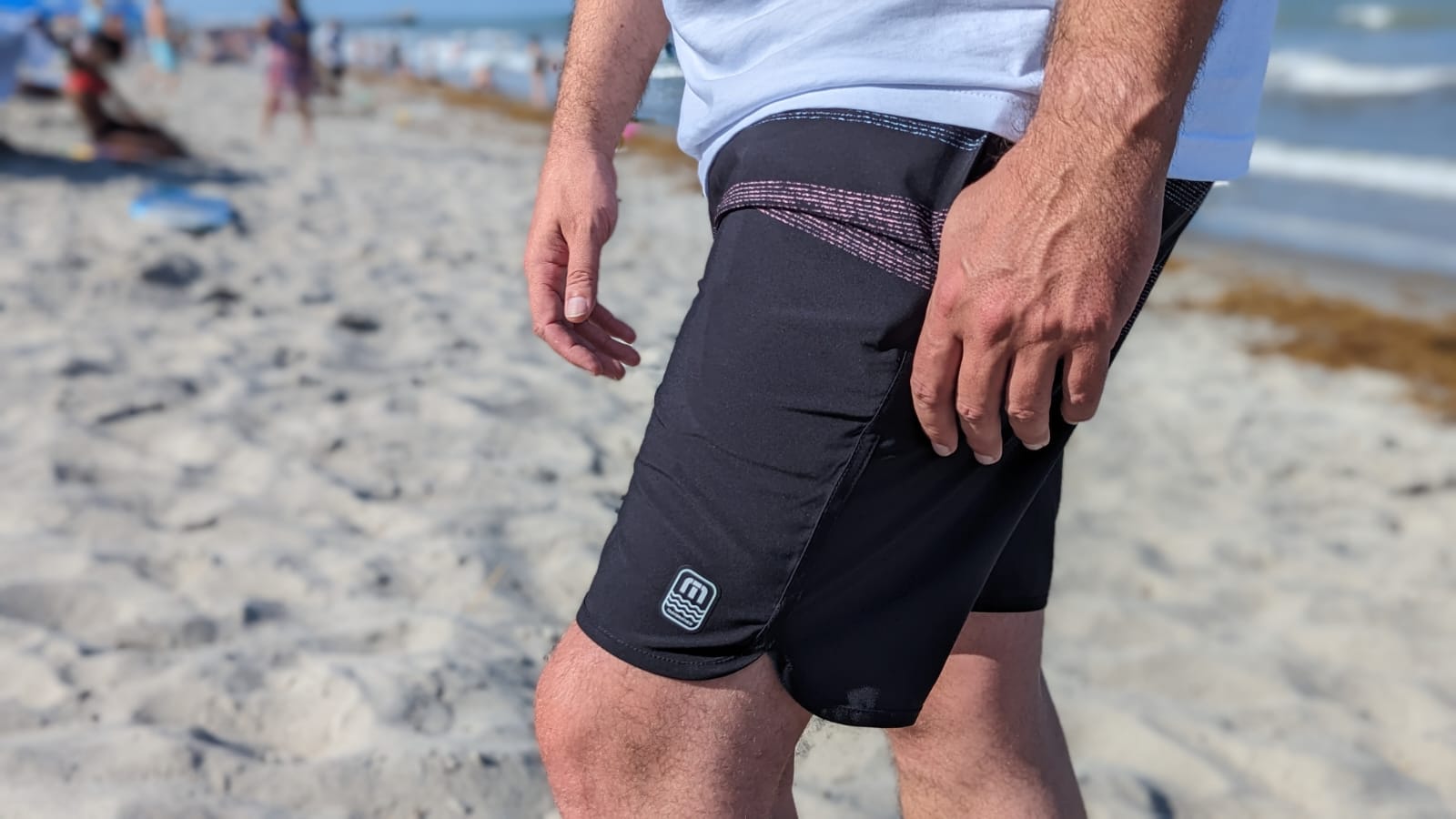 Man wearing Travis Mathew board shorts on the beach