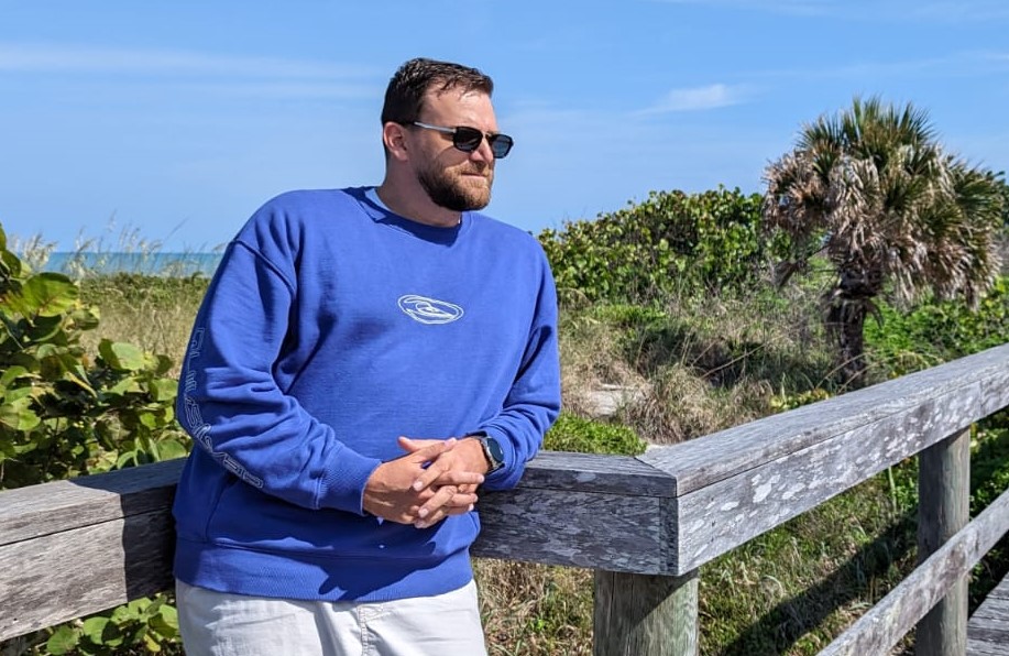 Man wearing Quicksilver sweatshirt and sunglasses