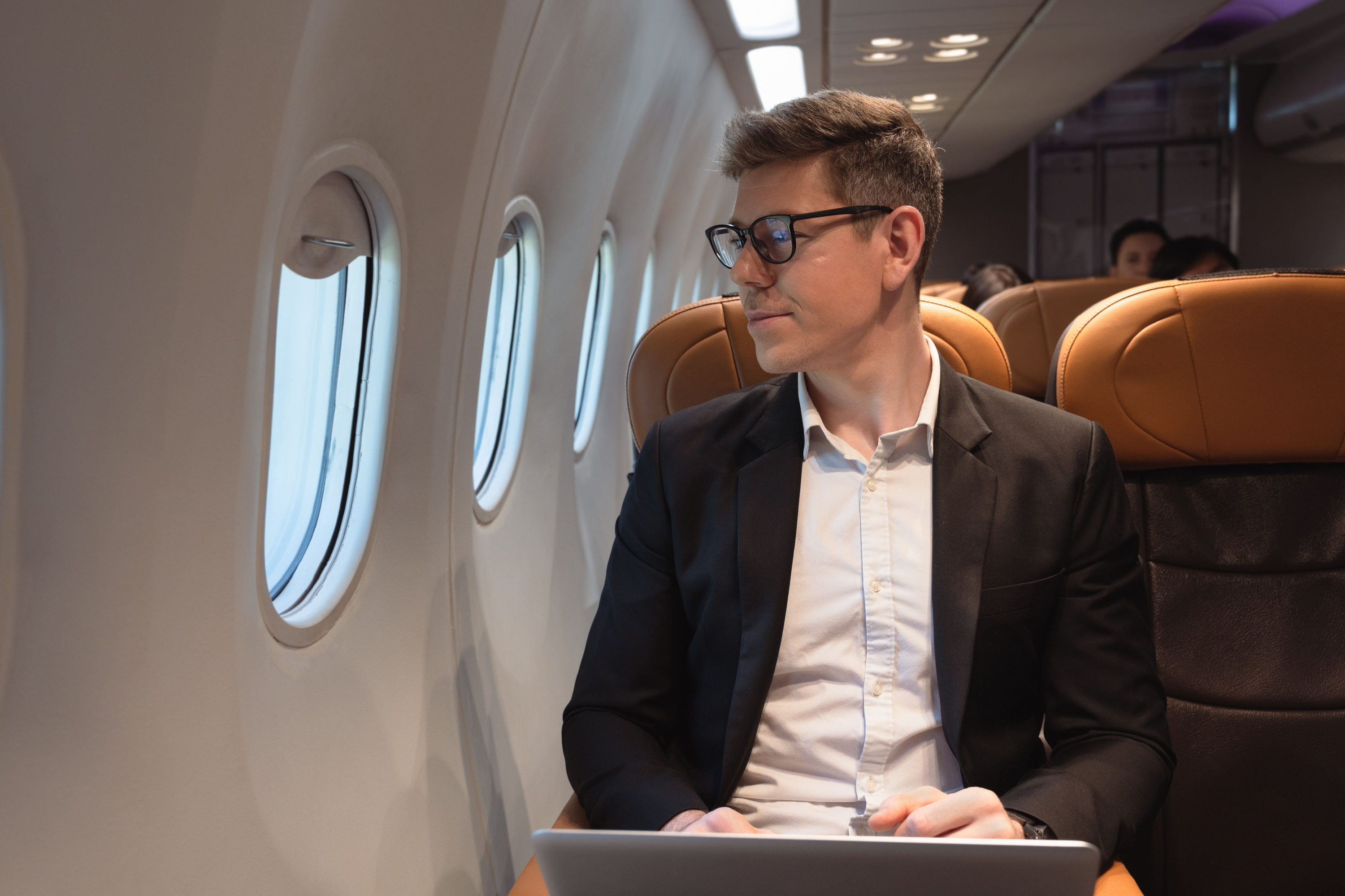 Man sitting in airplane looking out window