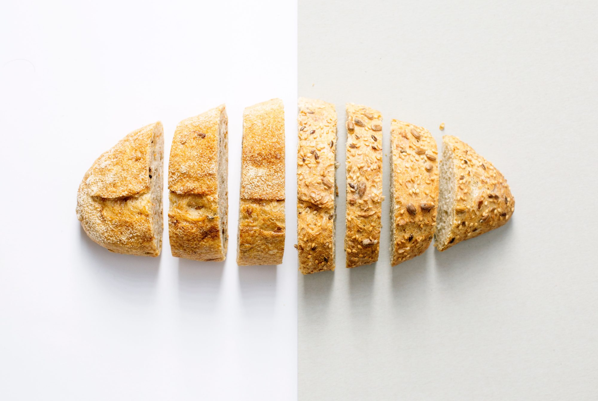 baked bread sliced on a white table