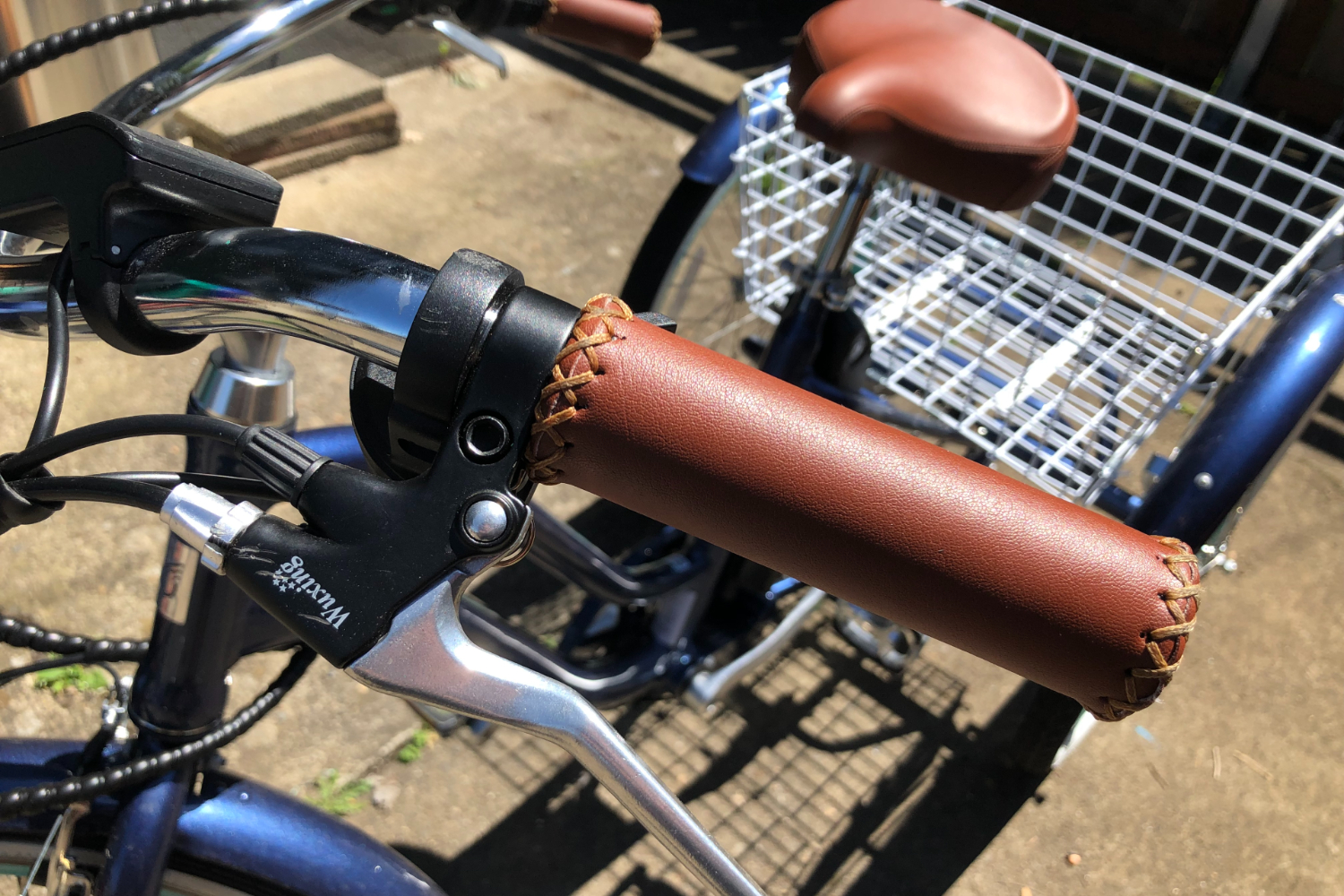 The grips and motor switch of the Sixthreezero e-trike.