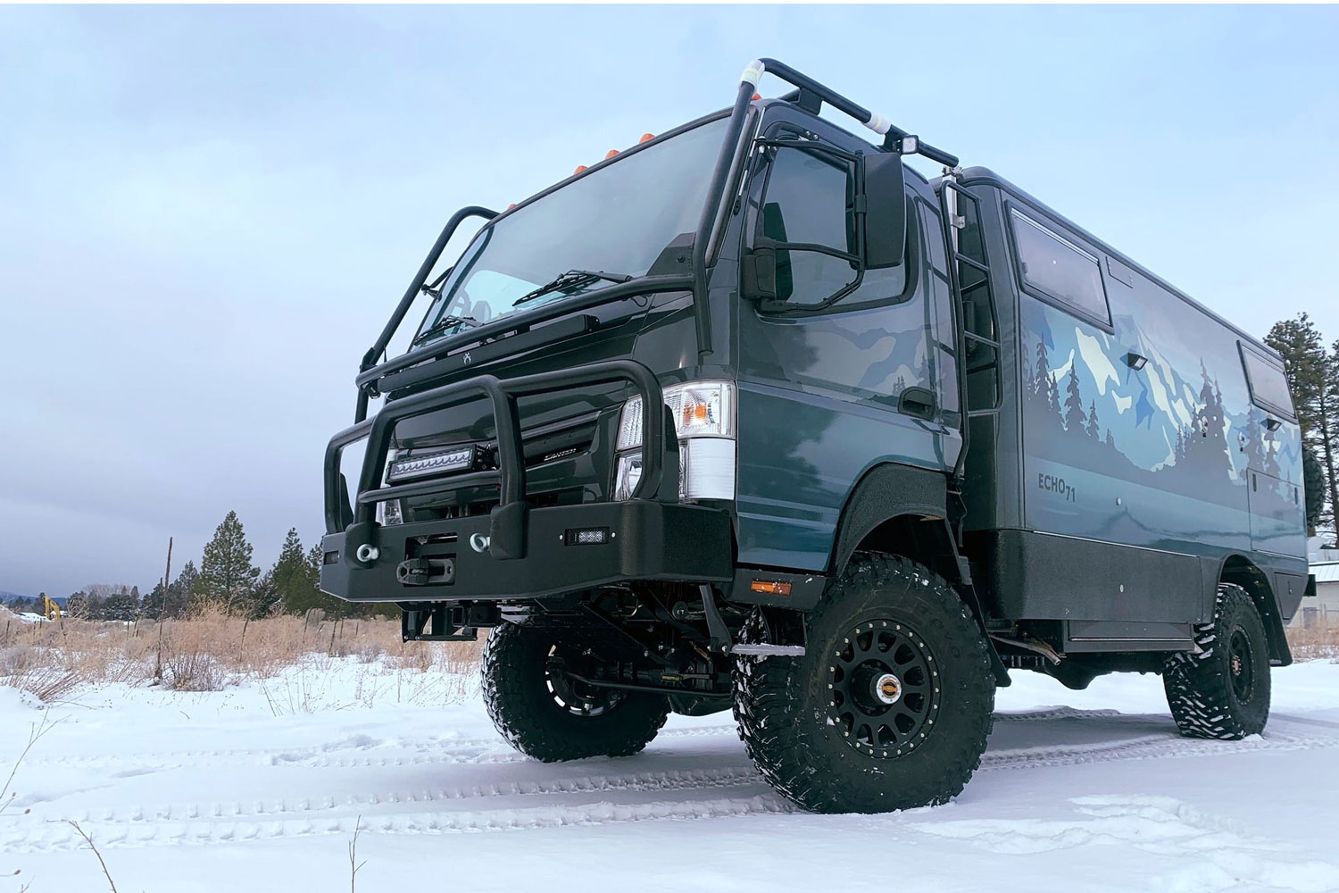 EarthCruiser EXP Overlander extreme overlanding vehicle on snowy terrain.