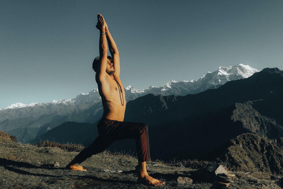 Man doing yoga outdoors.