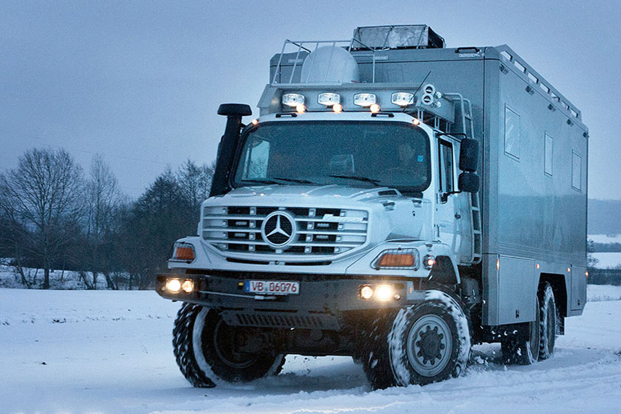 Mercedes Bens Zetros 6x6 Overlander Vehicle driving through snowy terrain.