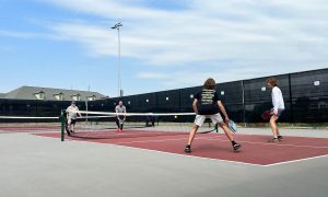 A group of people playing a game of pickleball.