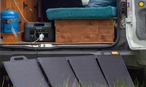 A Biolite basecharge unit and solar panel outside the back of a van