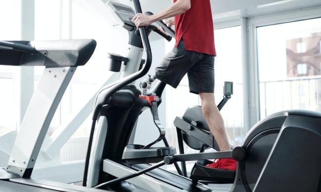 Man using elliptical.