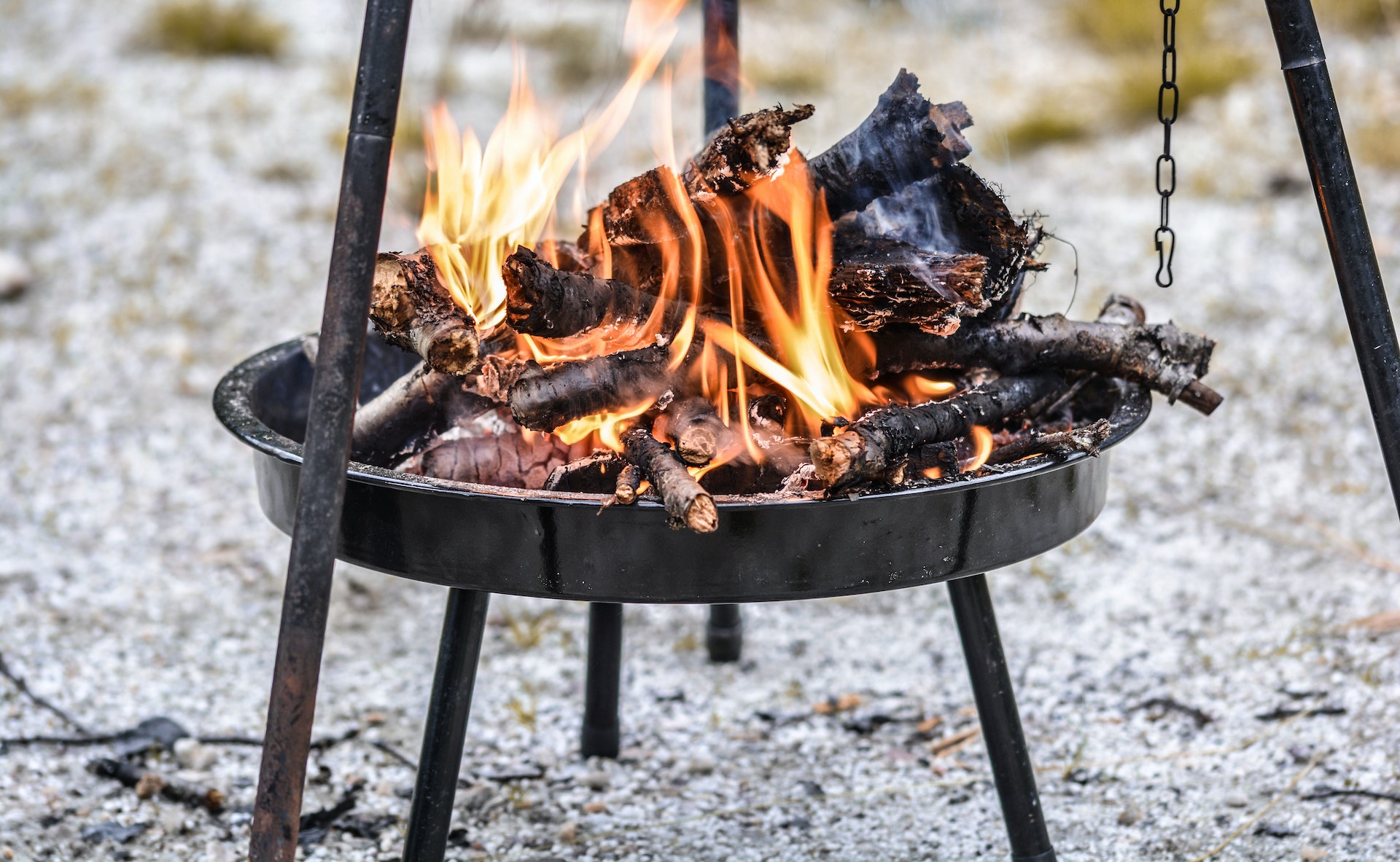 A fire burns away on a camping fire pit