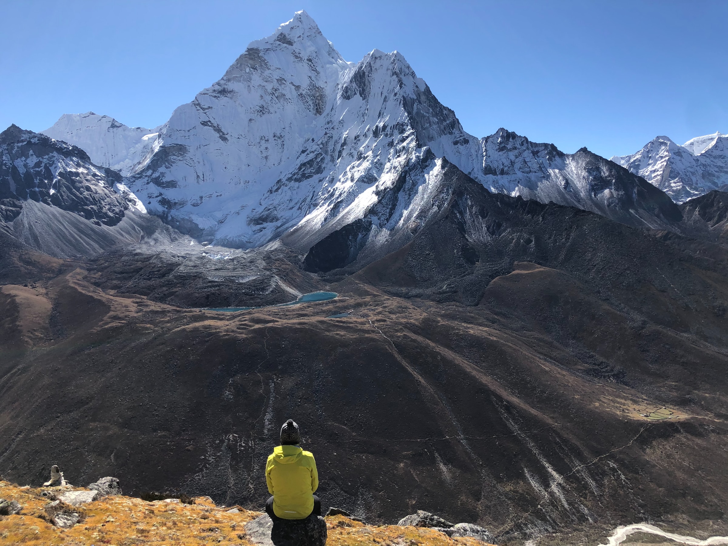 A hiker looks out over Mount Everest.