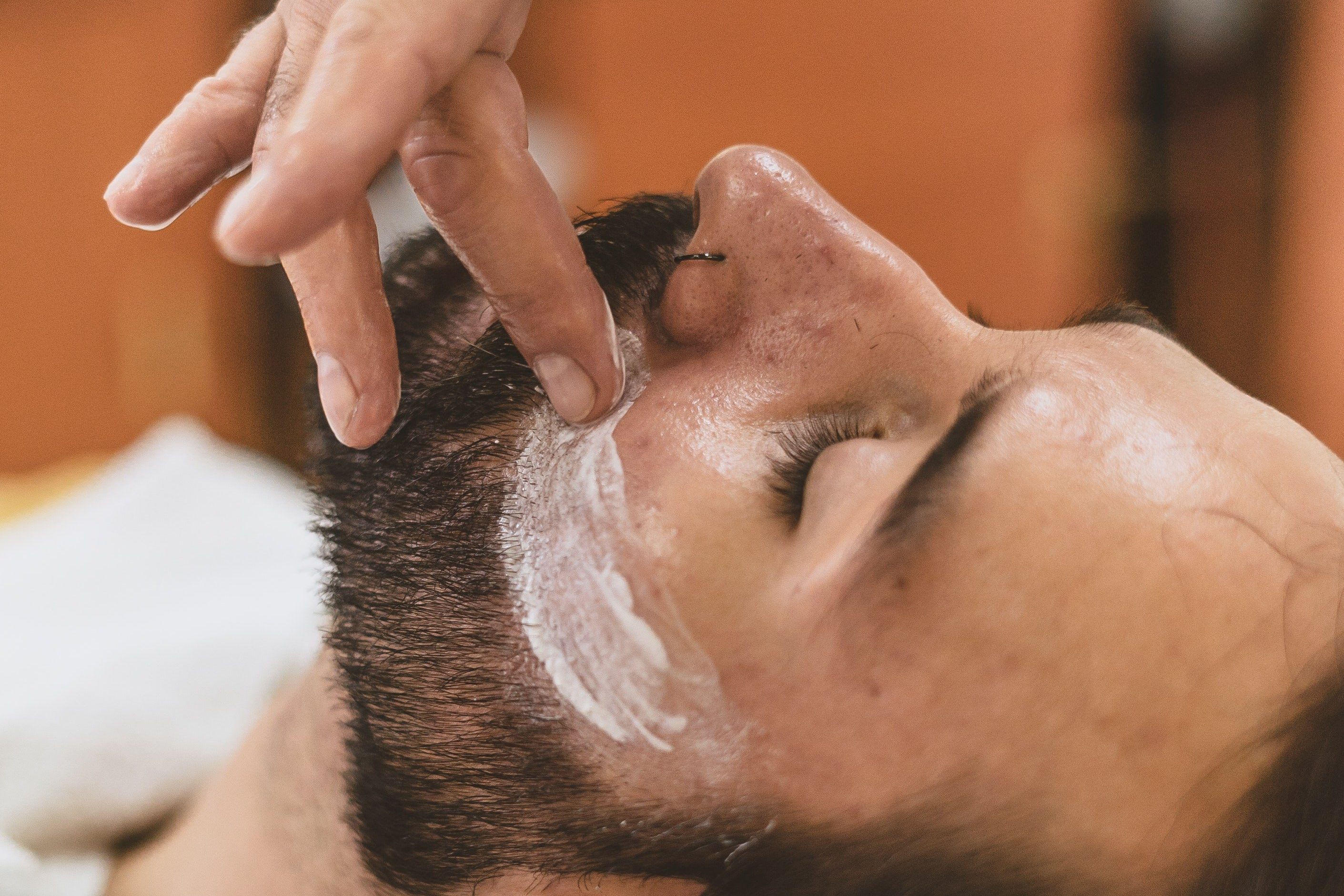 Man applying hair removal cream