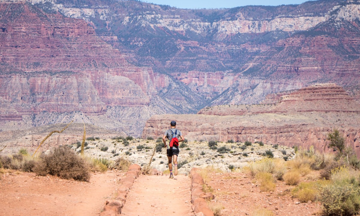 Man running through the desert landscape of The Grand Canyon.