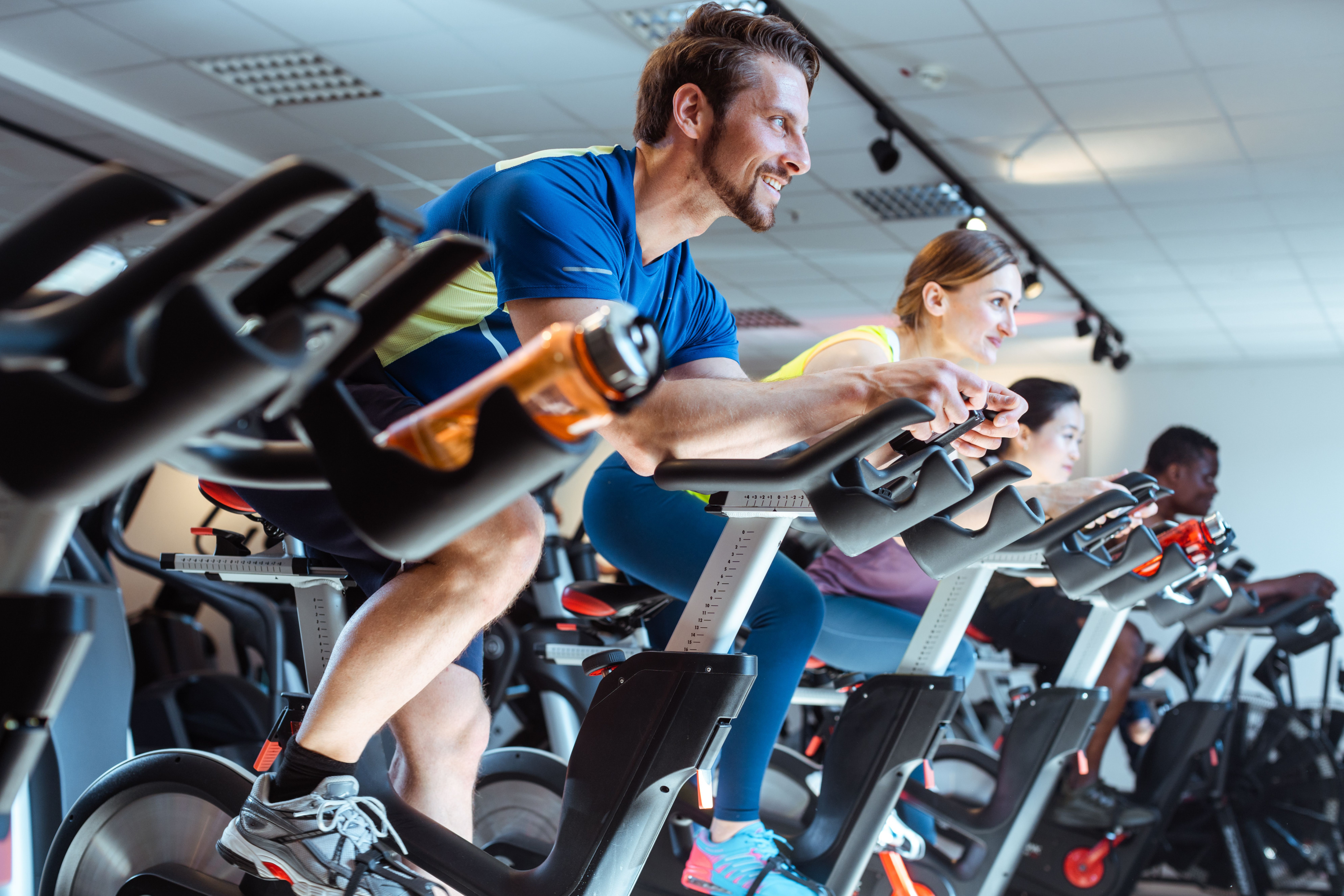 Man on exercise bike with others