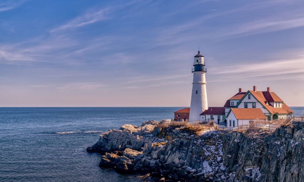 View from the water of Maine's Portland Head Lighthouse at sunset