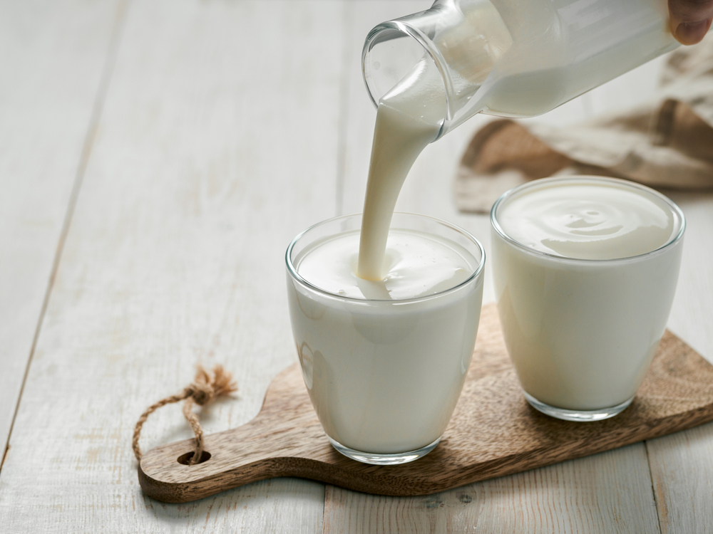 Buttermilk being poured into a glass.