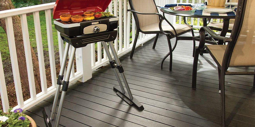 The Cuinsart Gourmet Portable Gas Grill on a porch.