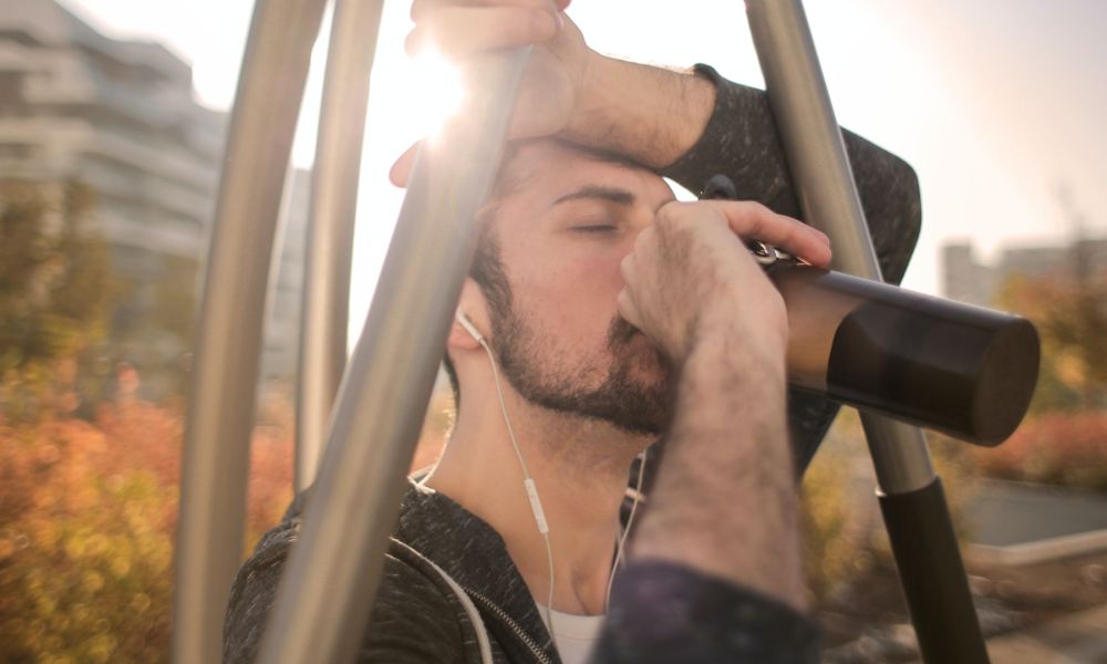 Man drinking water in the sunlight