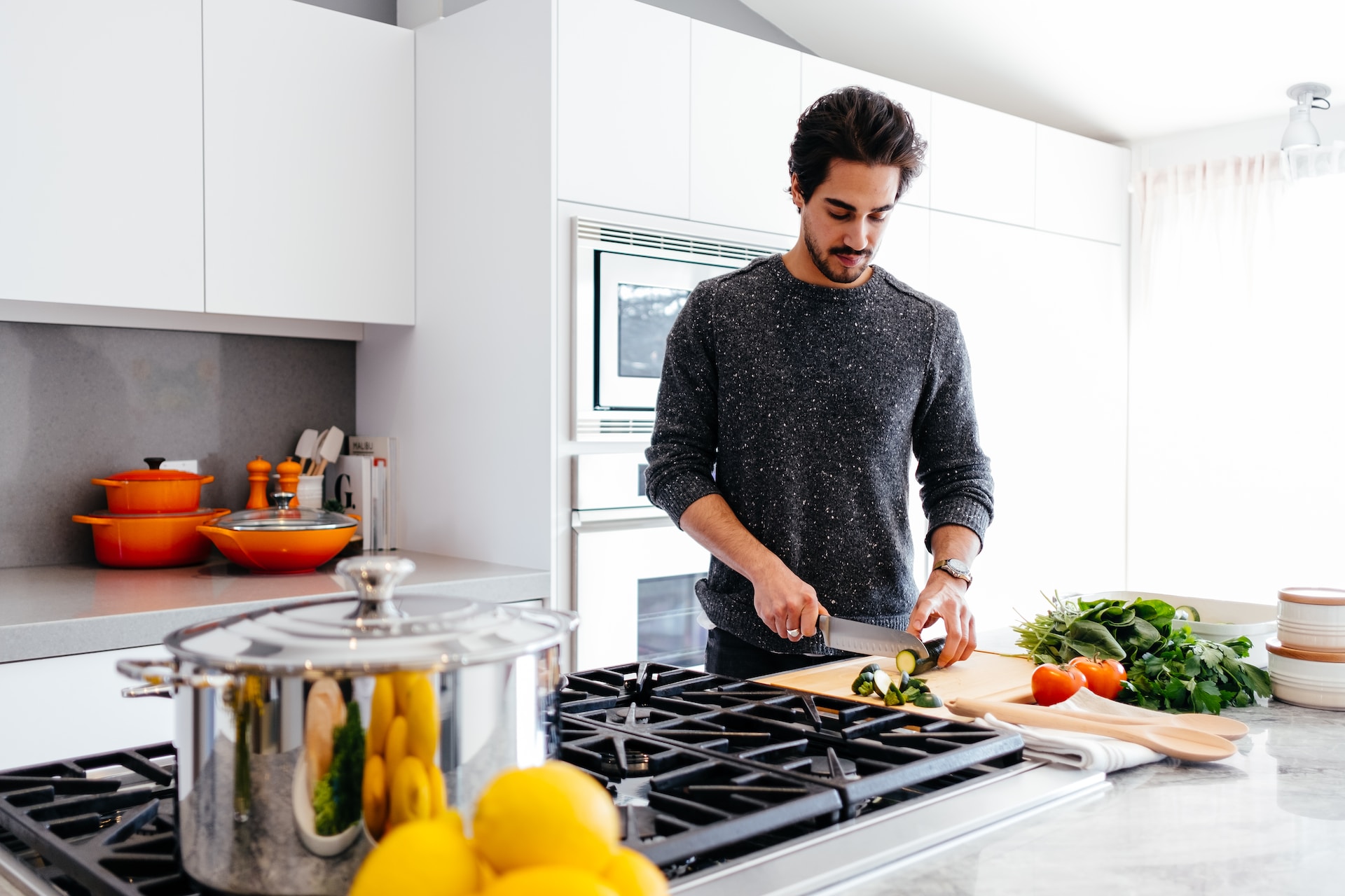 A person making dinner in the kitchen.