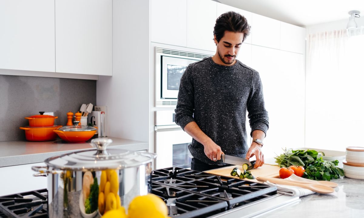 A person making dinner in the kitchen.