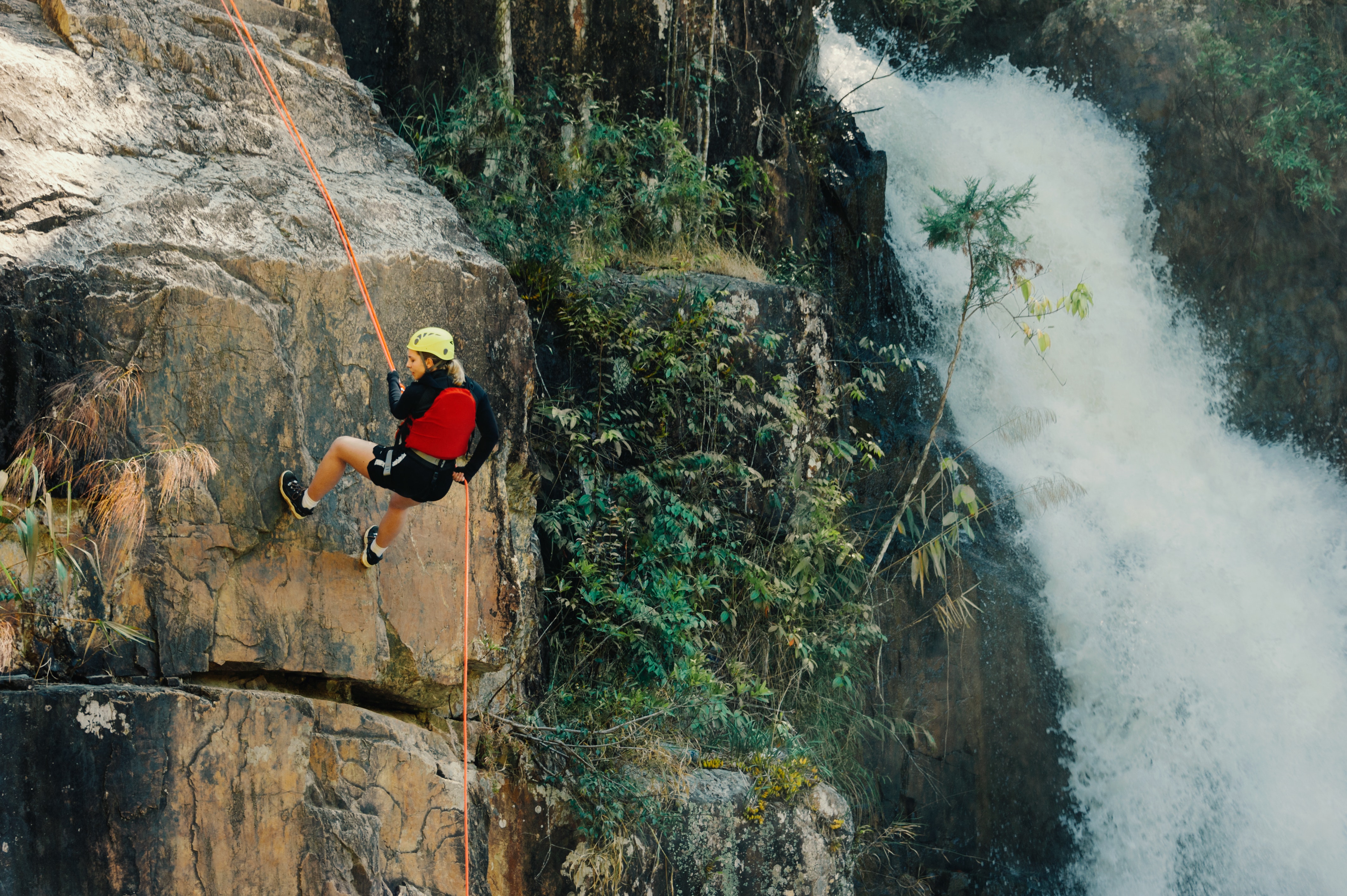 Person climbing a rock side