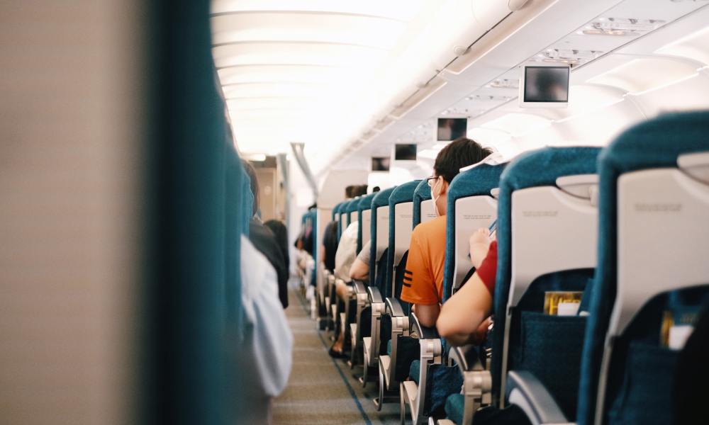 Back view of people seated on an airplane