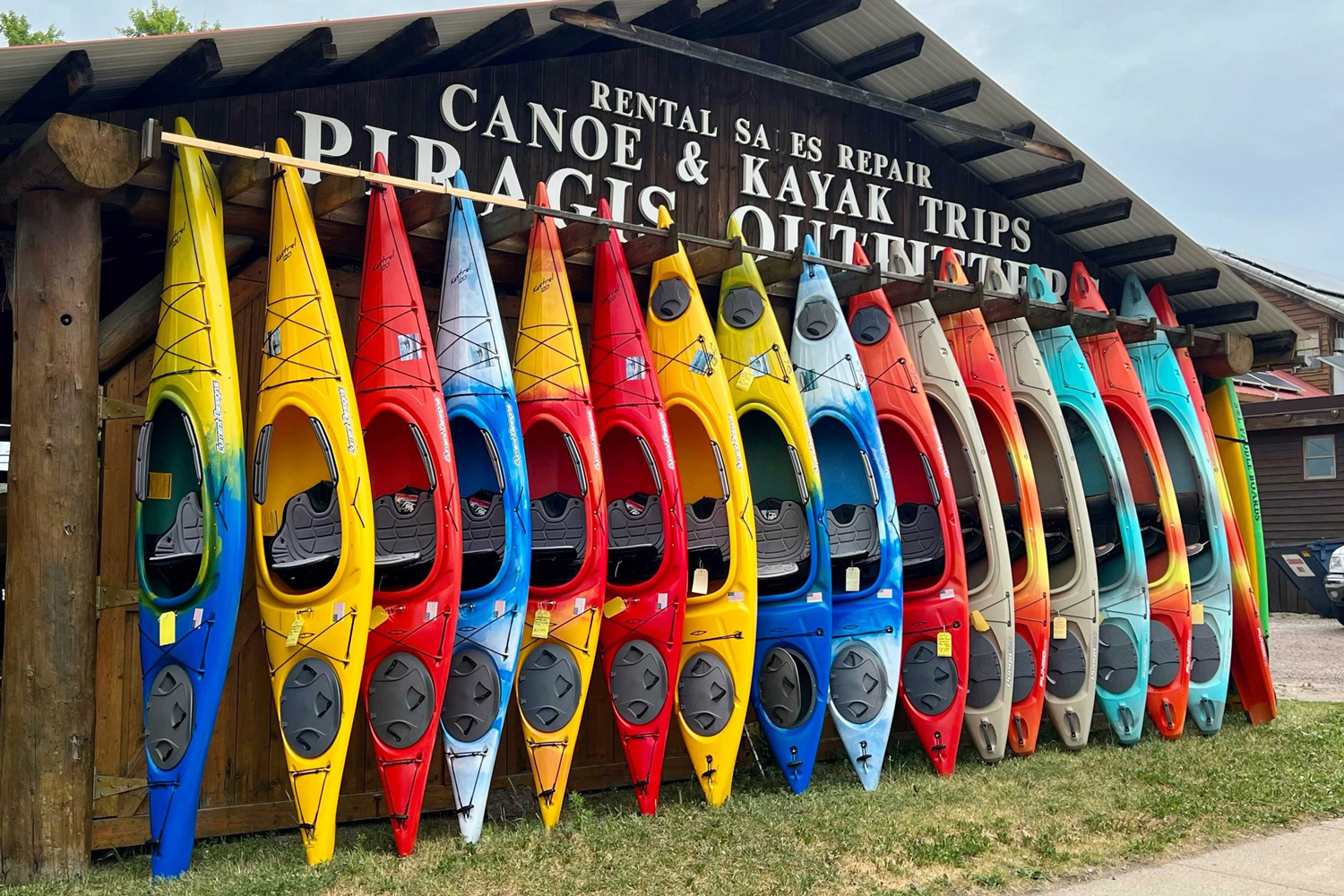 Colorful row of canoes lined up outside Piragis Northwoods Company in Ely, Minnesota.