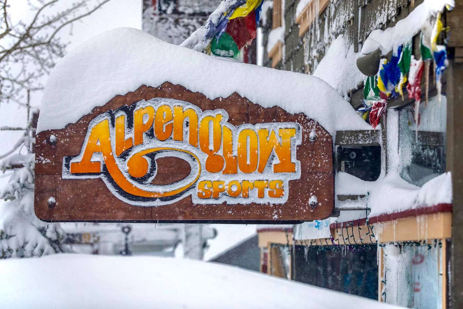 Snow covering the sign and entrance at Alpenglow Sports in Tahoe City, California.