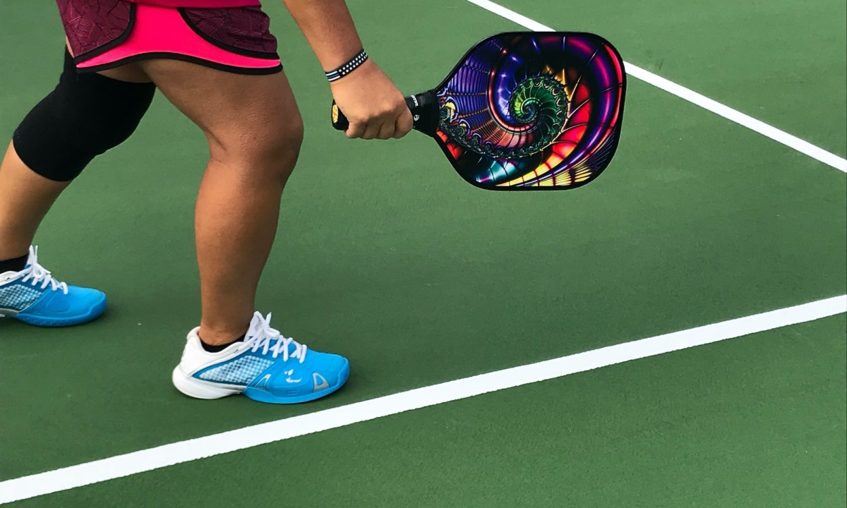 person showing pair of blue-and-white running shoes