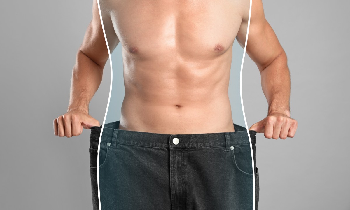 Closeup view of man with slim body in oversized jeans on grey background. Weight loss.