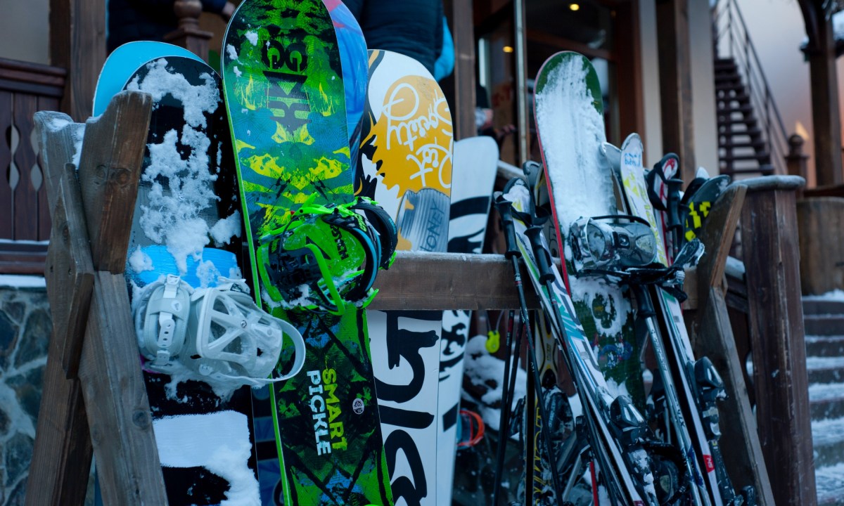 Skis and snowboards on a rack