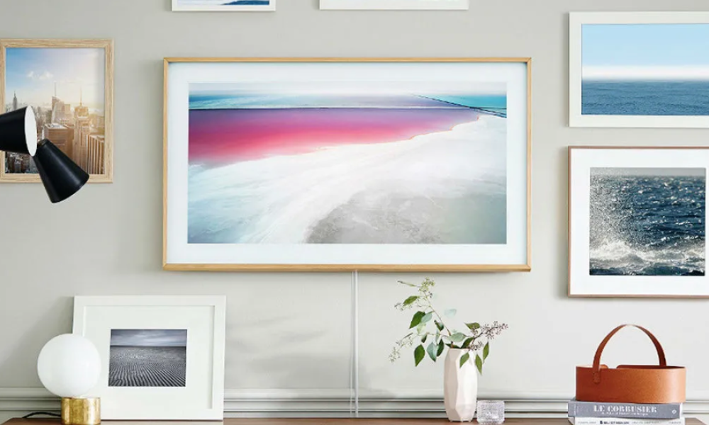 Samsung's The Frame on a wall surrounded by paintings and docarations