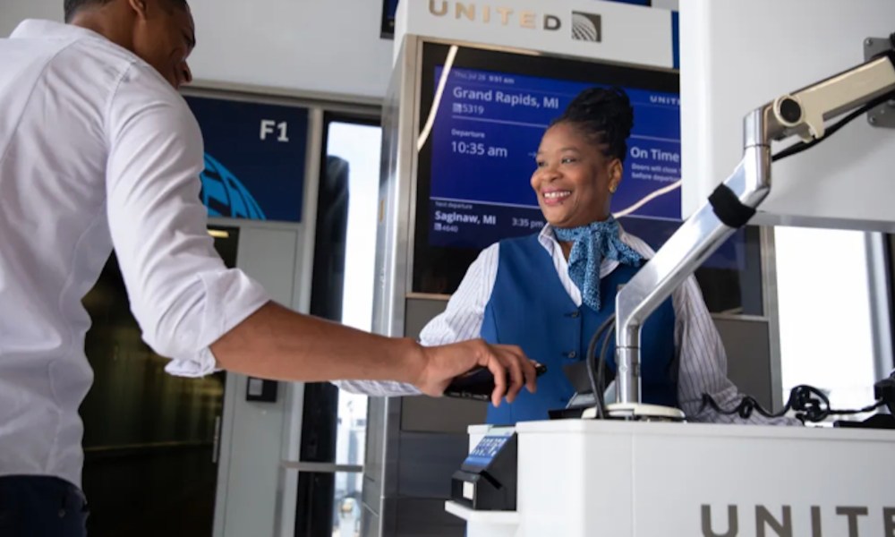 A passenger scans their boarding pass prior to boarding the plane.