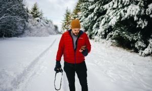 Man using phone in the snow.