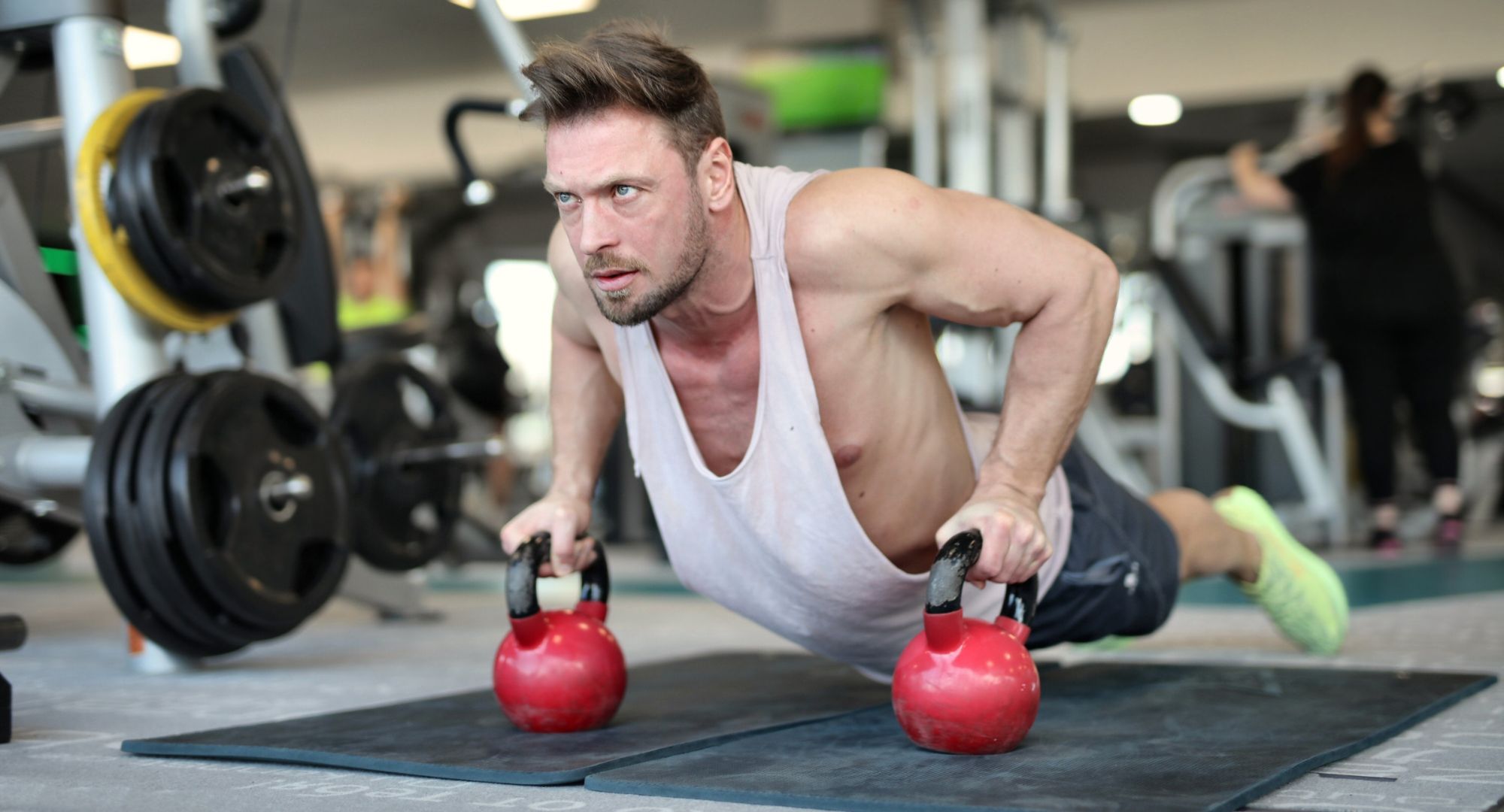 Man working out with red dumbbells