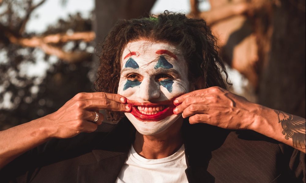 Man wearing "Joker" face paint