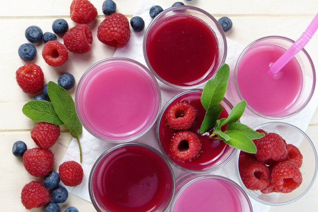 Full cups of fruit juices and berry smoothies on the table