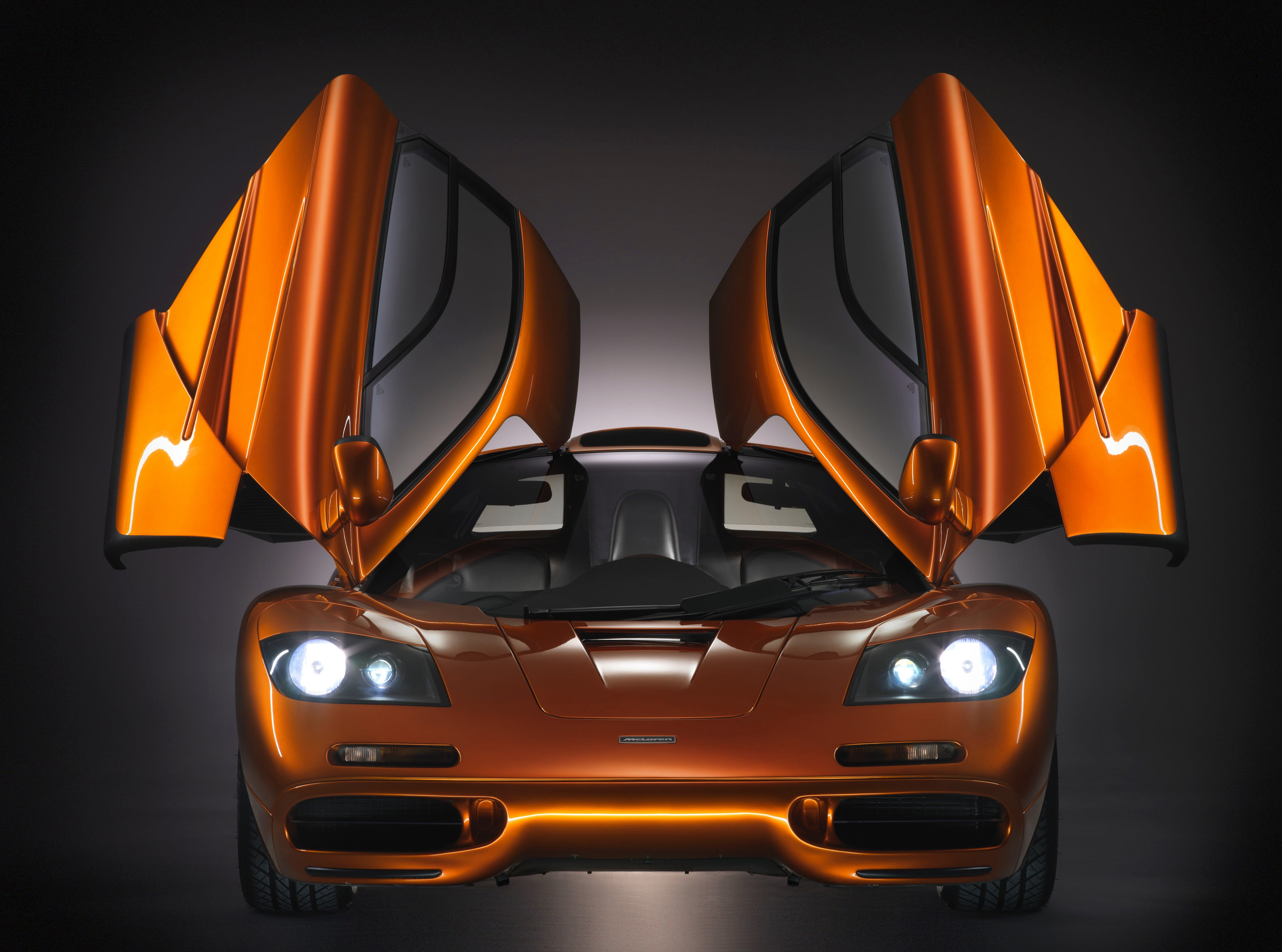 Orange McLaren F1 with butterfly doors open