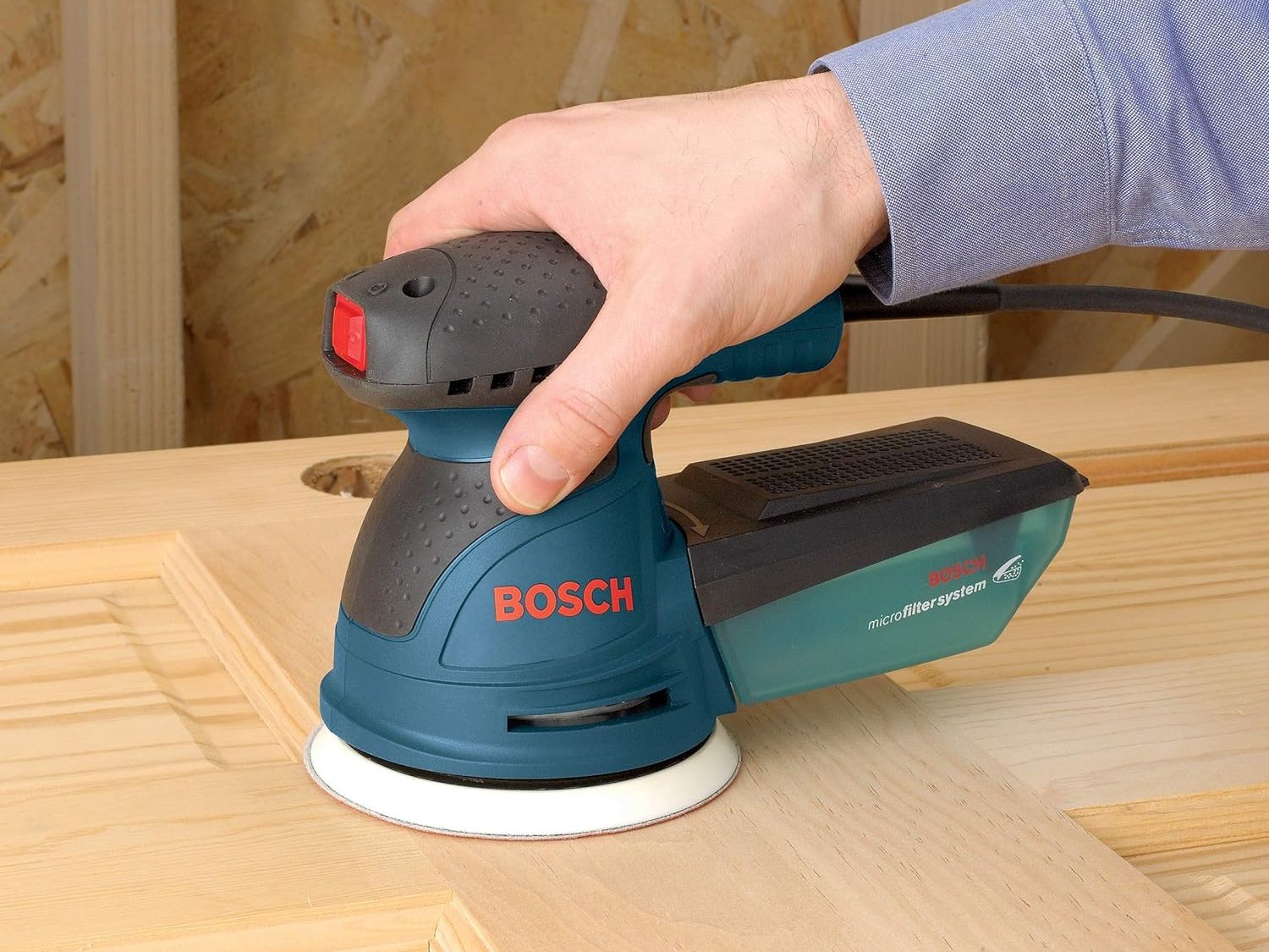 A corded Bosch Palm Sander with the Bosch logo clearly displayed.