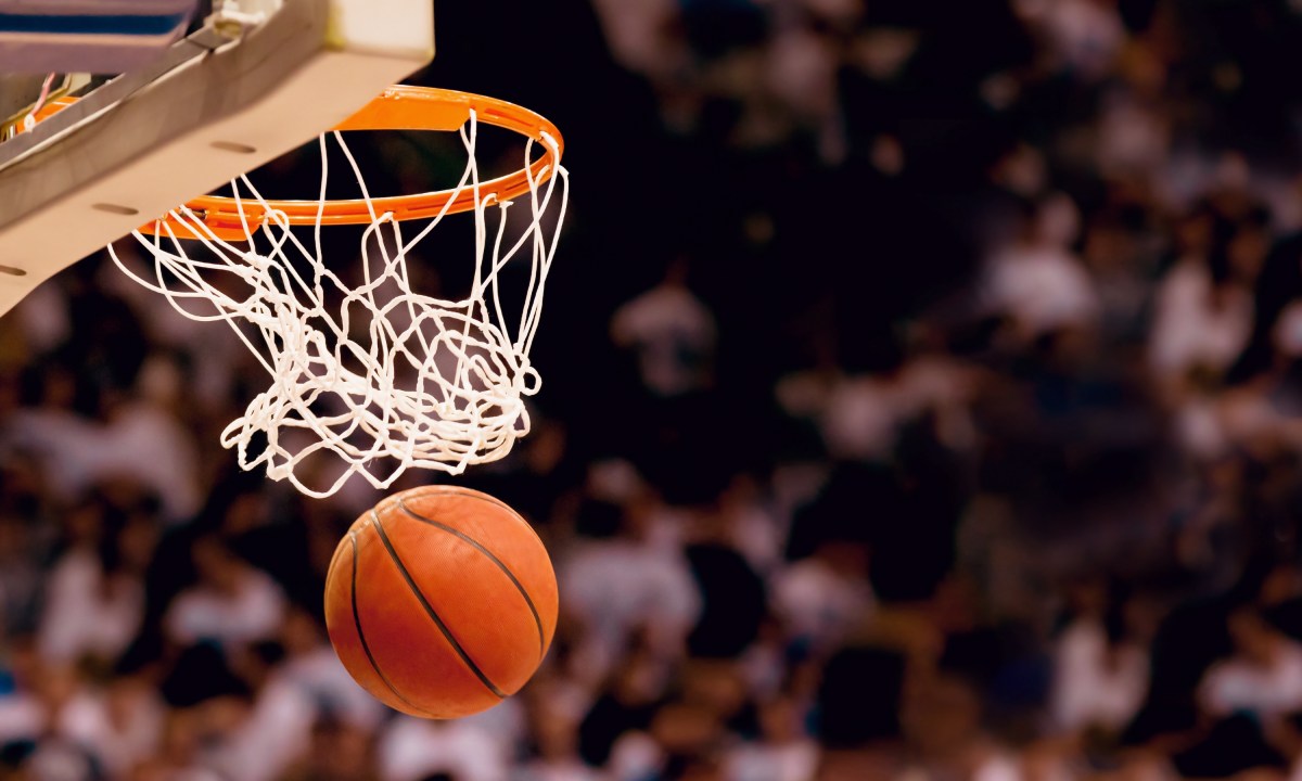 Basketball ball going through the hoop