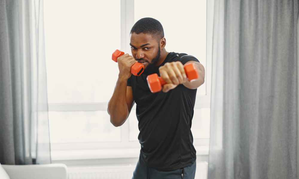 man holding dumbells in workout