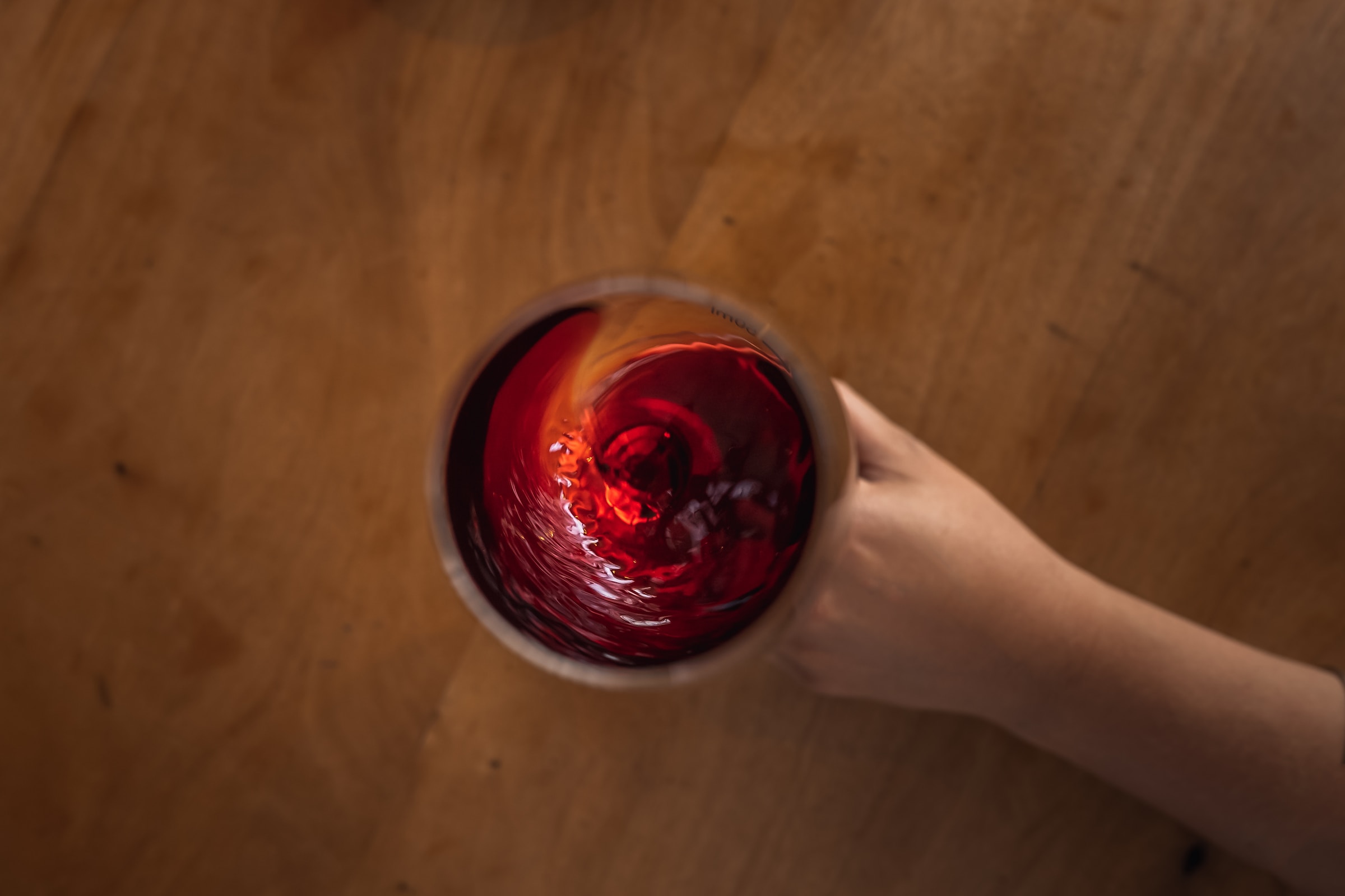 Red wine swirling in glass