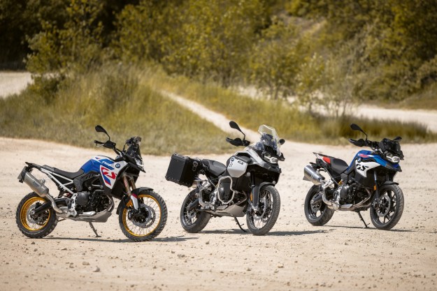 Three versions of the 2024 BMW F 900 GS motorcycle.