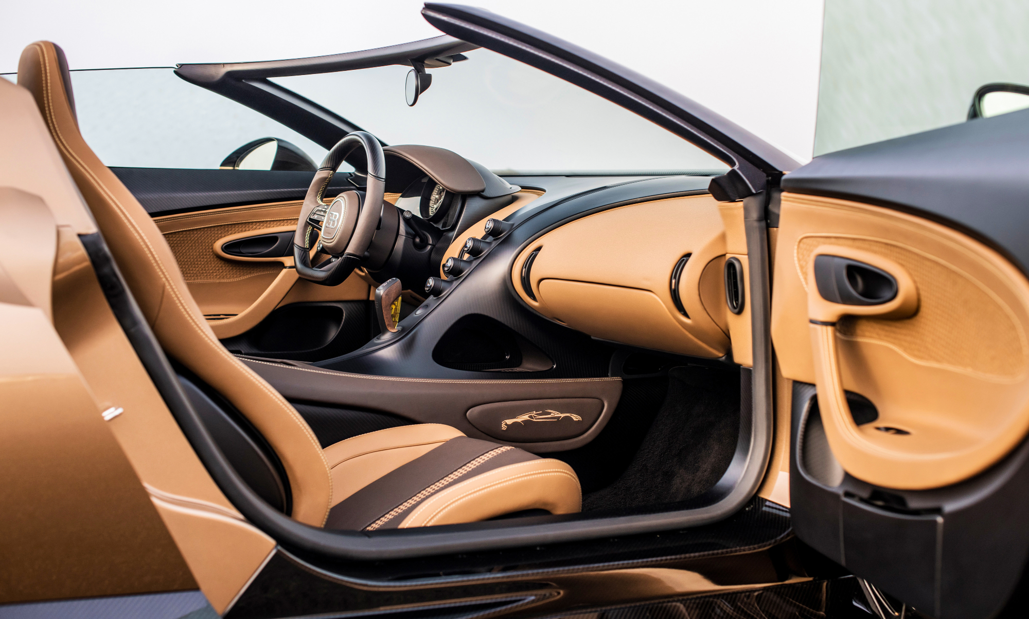 Bugatti W16 Mistral Roadster interior of the car taken from outside the car on the passenger side with the door open.