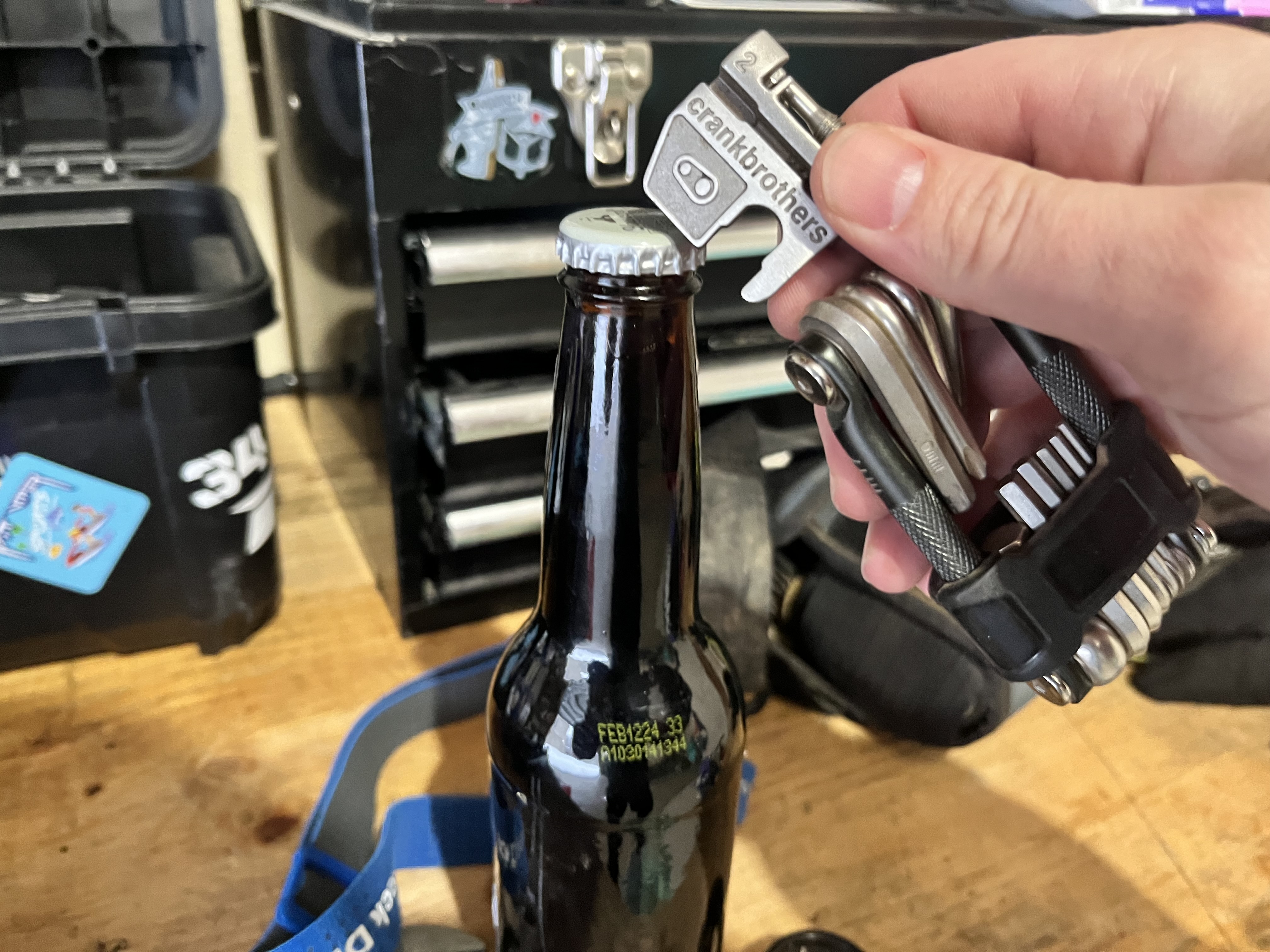 Using a mountain bike multi-tool to open a beer