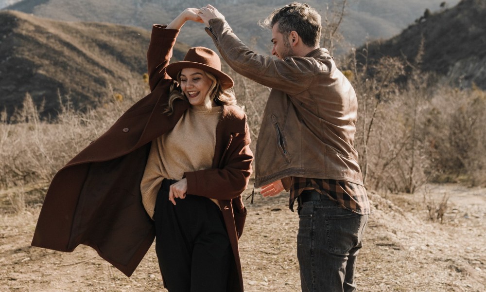 Man dancing with a woman in suede jacket