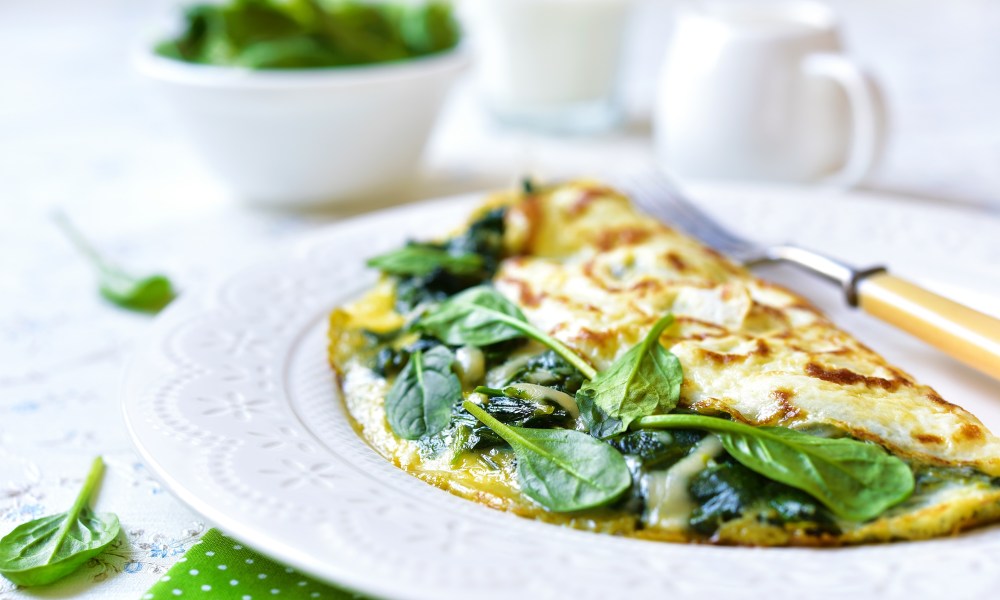 Omelette stuffed with spinach and cheese for a breakfast.