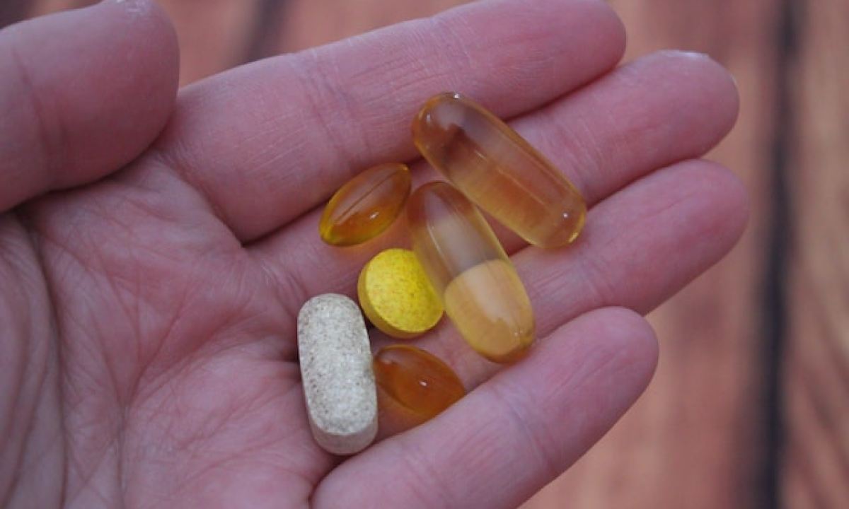 person holding vitamins in hand