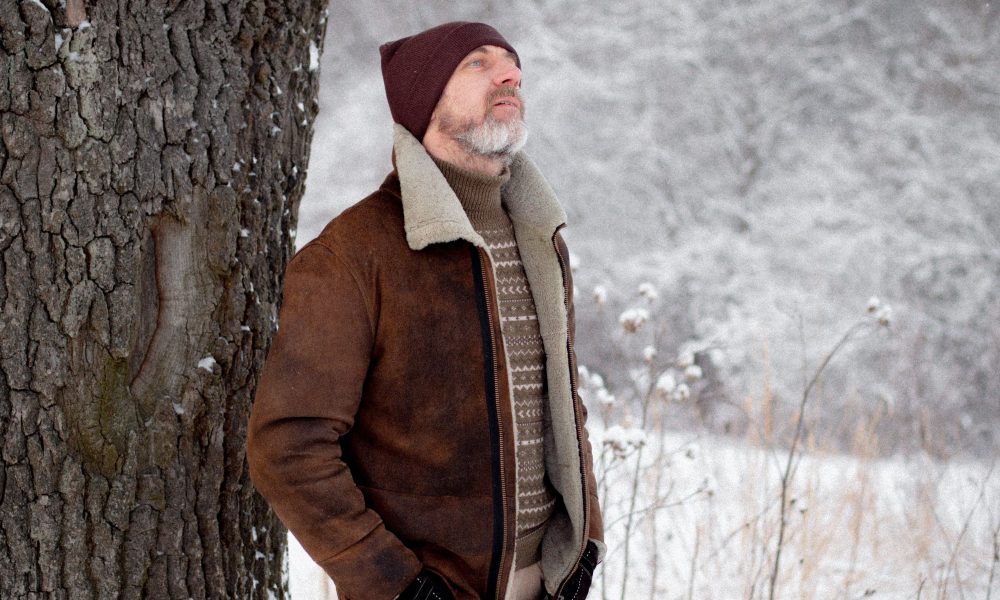 Man in suede coat in the snow